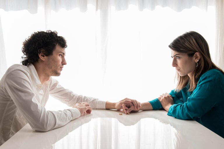 Couple discussing HSV-2 and dating concerns in a supportive conversation.