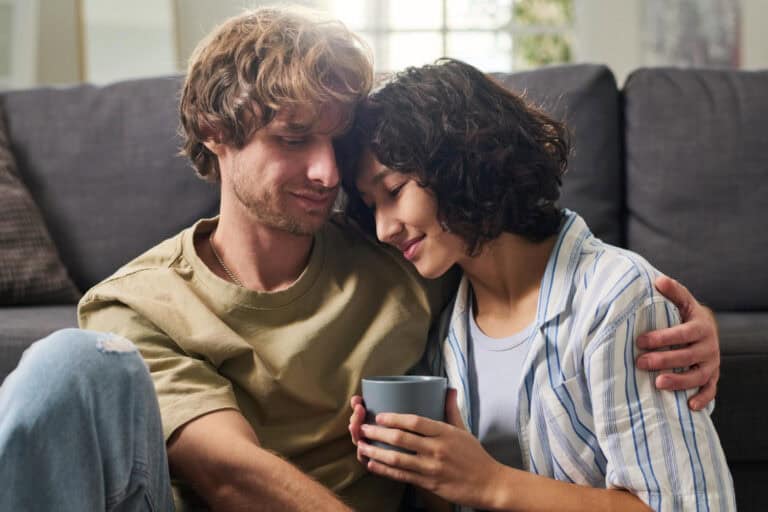 Couple discussing HIV status on a mobile phone at home.